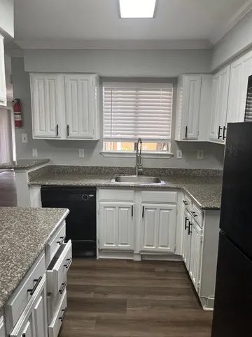 a view of empty room with wooden floor and fireplace
