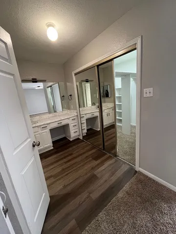 a view of walk in closet with empty racks