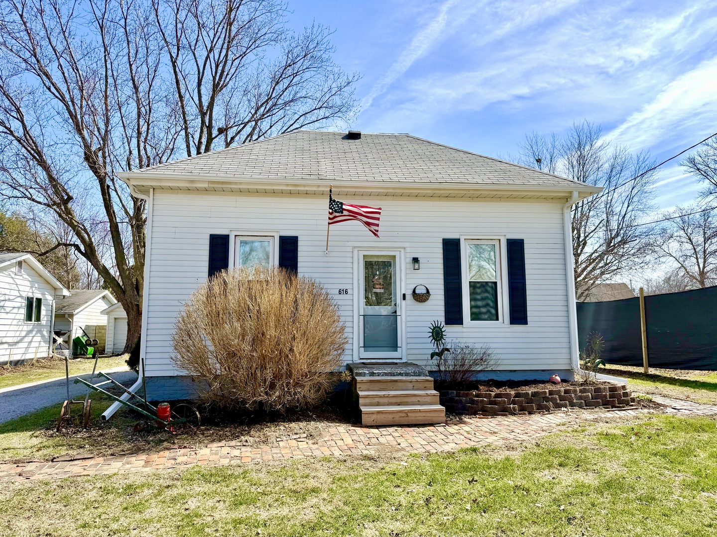 a view of a house with a yard covered in snow