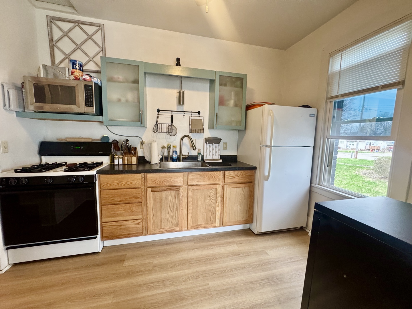 616 Northwest 2nd Avenue Aledo, IL 61231 - Photo 9 of 26 a kitchen with a refrigerator and a stove top oven