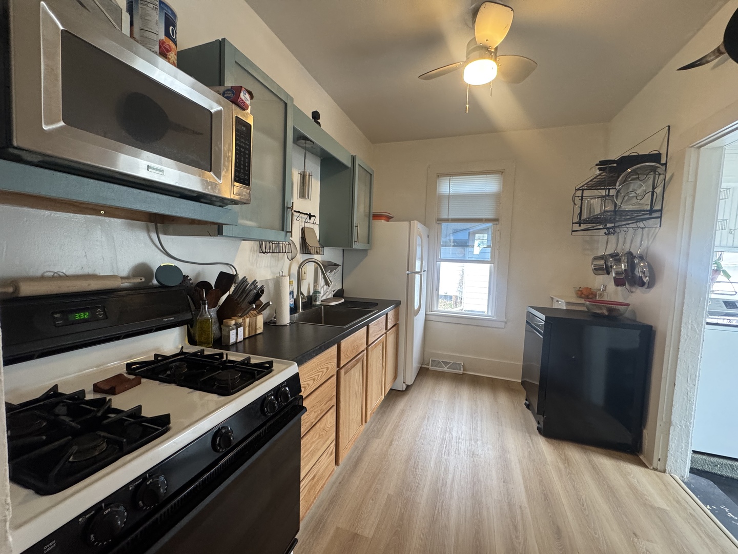 616 Northwest 2nd Avenue Aledo, IL 61231 - Photo 10 of 26 a kitchen with stainless steel appliances a stove a sink dishwasher and cabinets with wooden floor