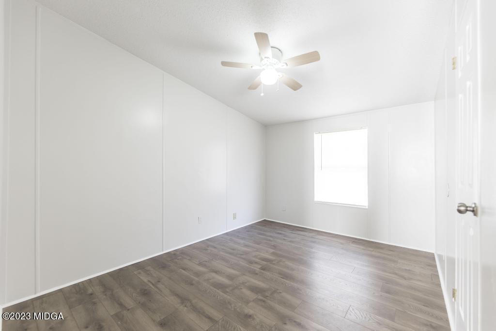 208 Colonial Drive Byron, GA 31008 - Photo 23 of 38 wooden floor in an empty room with a window