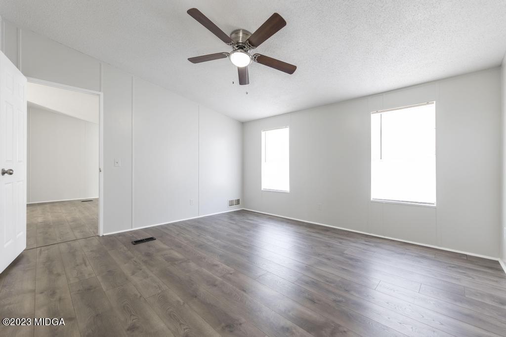 208 Colonial Drive Byron, GA 31008 - Photo 29 of 38 an empty room with wooden floor and windows
