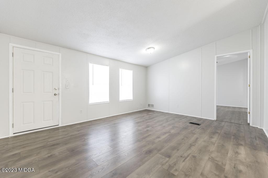 208 Colonial Drive Byron, GA 31008 - Photo 9 of 38 an empty room with wooden floor and windows