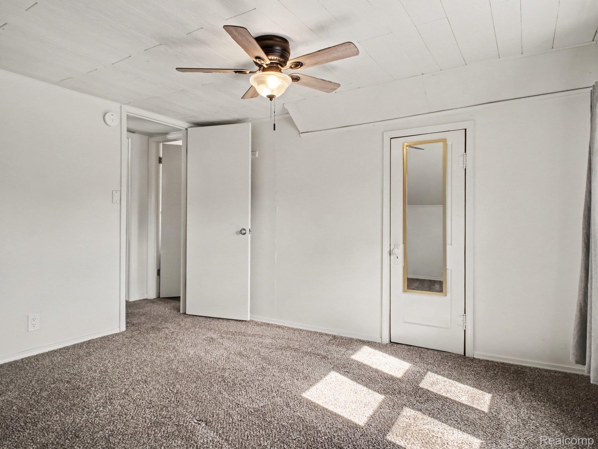 2840 Miller Road Flint, MI 48503 - Photo 27 of 49 Textured ceiling with a ceiling fan, light gray carpeting, and white painted walls