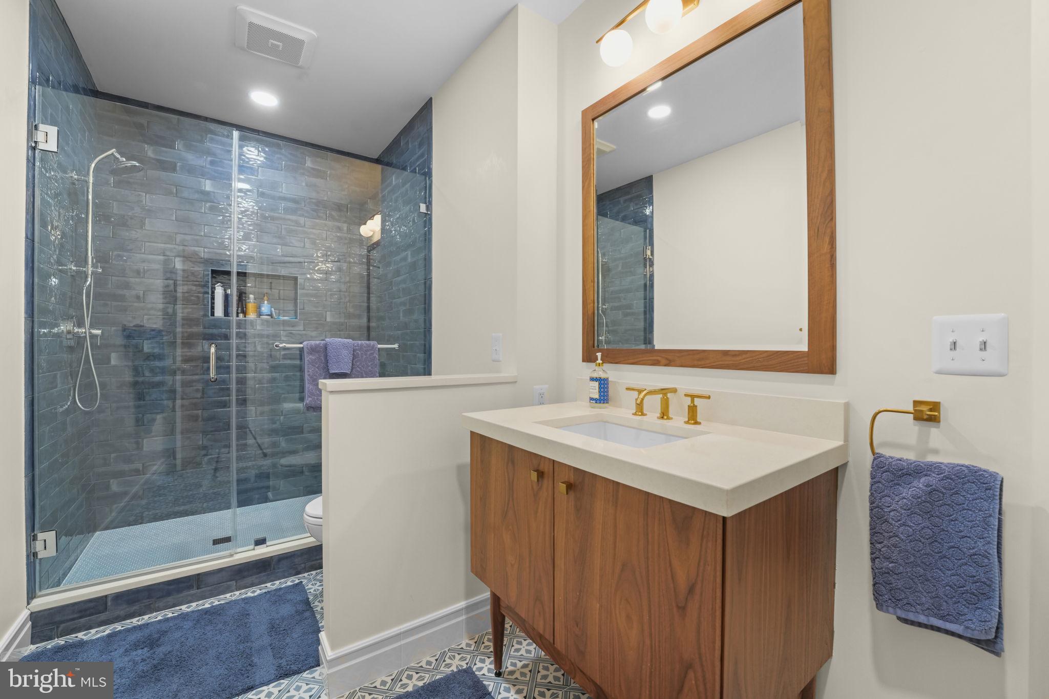 11431 Woolington Road Great Falls, VA 22066 - Photo 28 of 49 a bathroom with a sink a toilet and shower