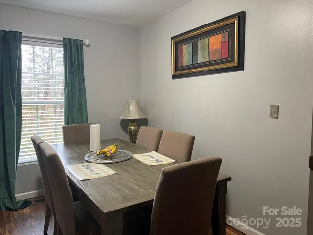 a view of a dining room with furniture and window