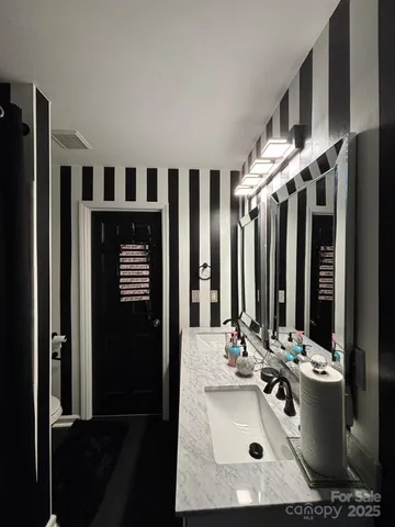 a bathroom with a sink double vanity and a mirror