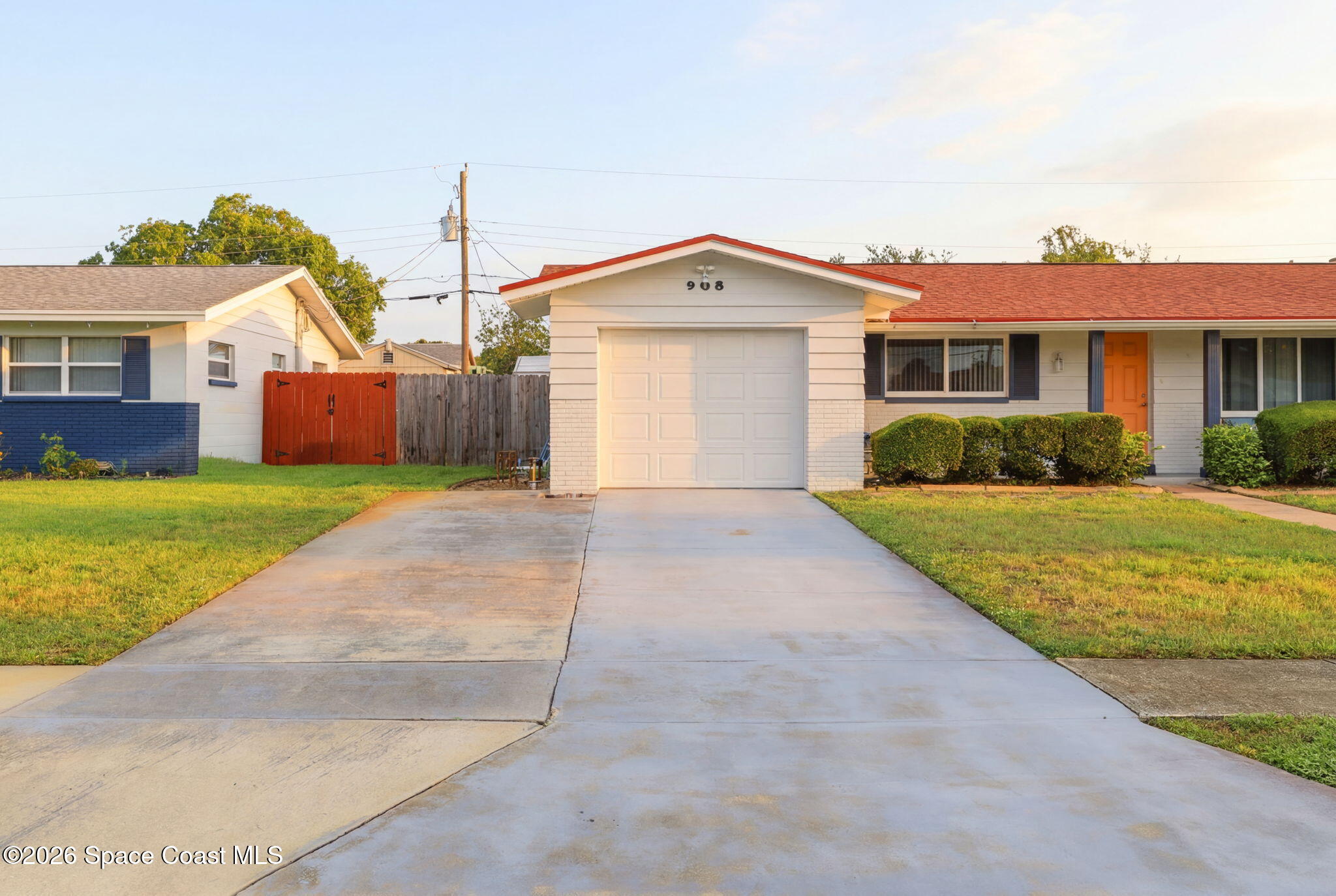 908 Jefferson Road Rockledge, FL 32955 - Photo 28 of 37 a front view of a house with a yard and garage