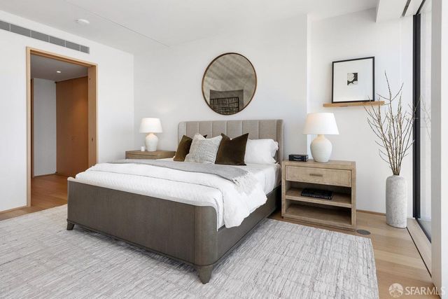 a bedroom with a bed and a mirror