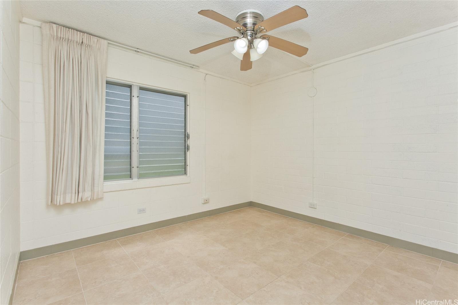 45-535 Luluku Road, Unit G2 Kaneohe, HI 96744 - Photo 7 of 12 an empty room with a window and a fan