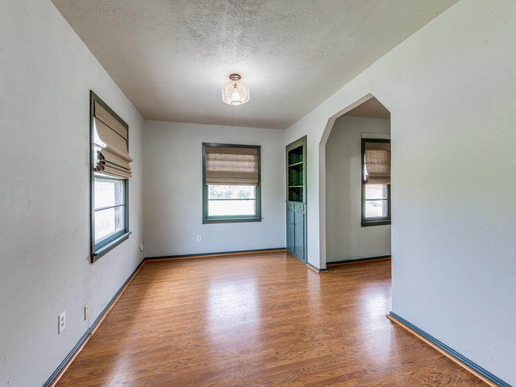 5317 Redbud Lane Fort Worth, TX 76114 - Photo 15 of 16 an empty room with wooden floor and windows