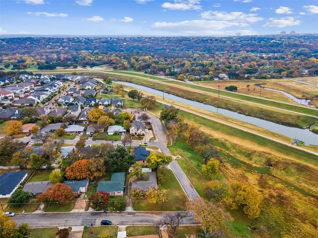 an aerial view of residential houses with outdoor space and swimming pool