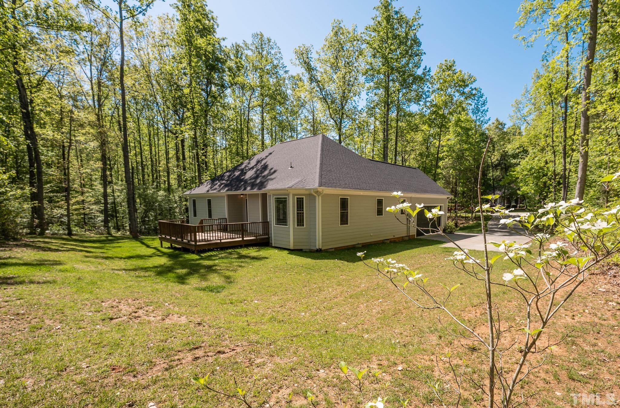 755 Oaks Lane Road Timberlake, NC 27583 - Photo 50 of 57 a front view of a house with swimming pool and sitting area