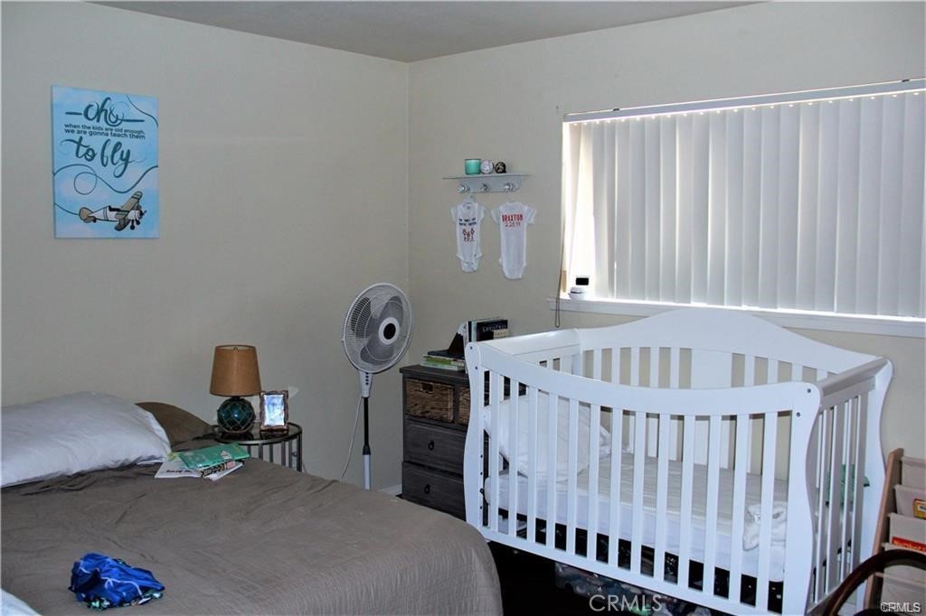 34591 Via Verde, Unit A Dana Point, CA 92624 - Photo 7 of 13 a bedroom with furniture and baby crib