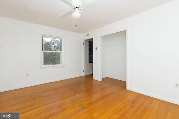 a view of an empty room with a fireplace and a window