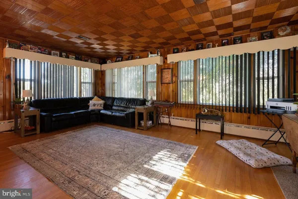 a living room with furniture rug and wooden floor
