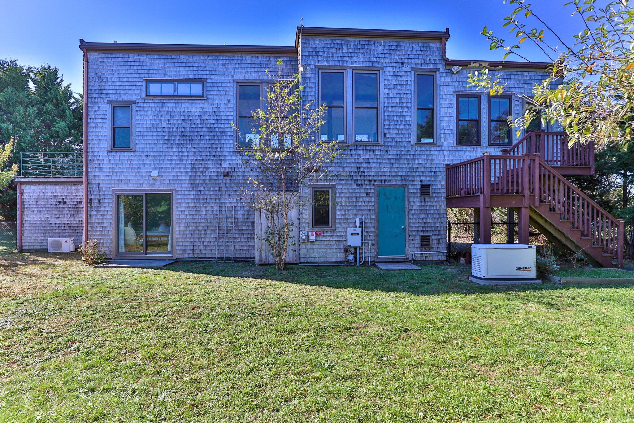 18 Bay View Road Truro, MA 02666 - Photo 13 of 30 a large brick building with a yard in front of it
