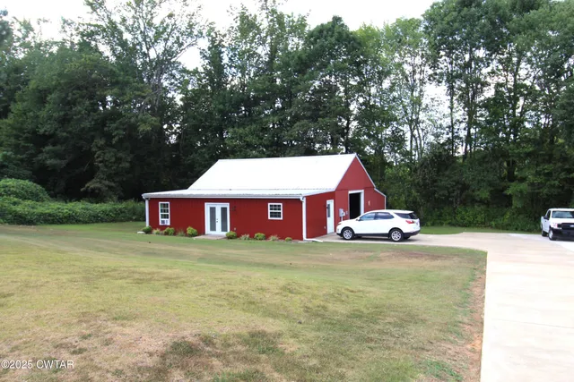 a view of a house with a yard and trees