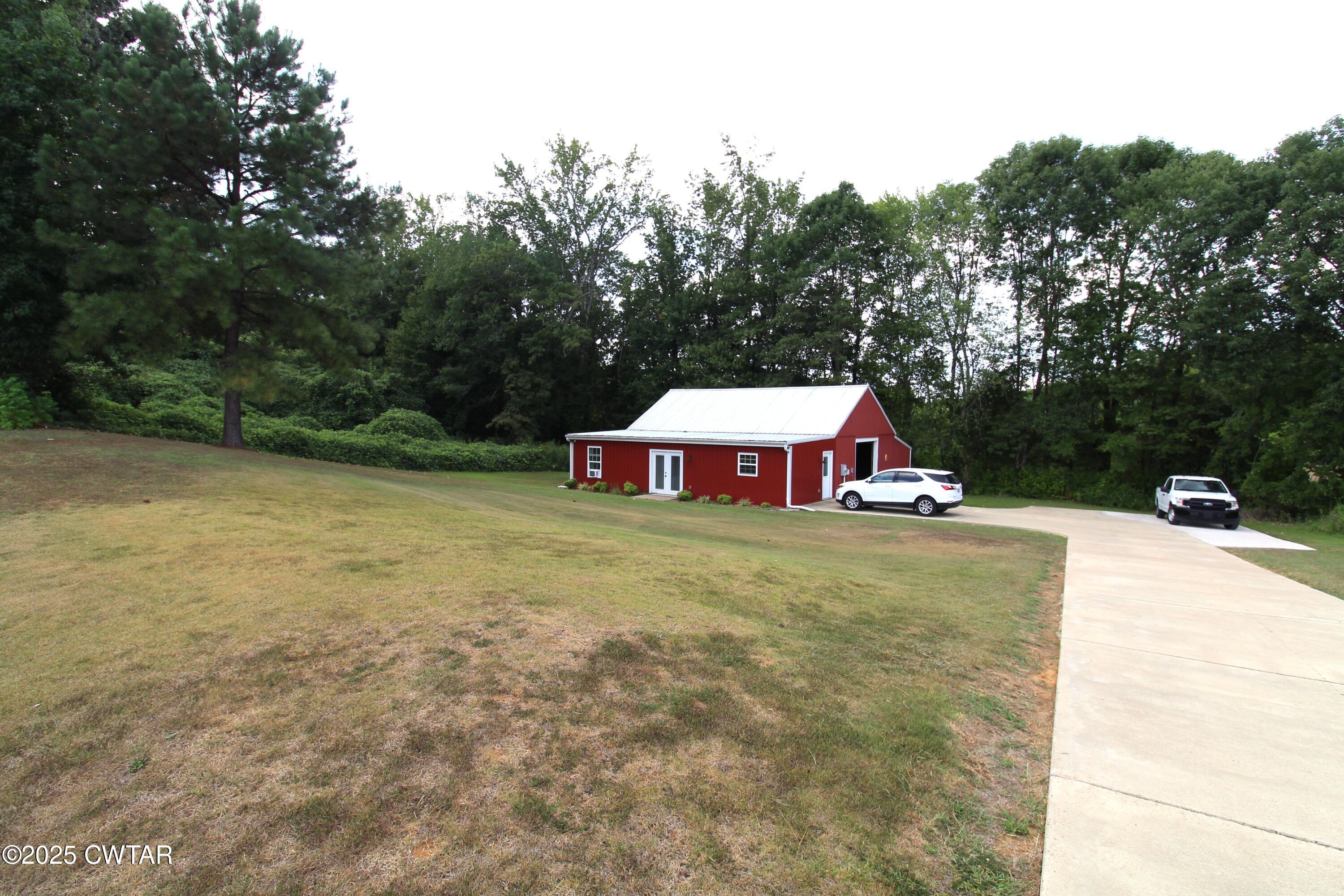 3125 Old Huntingdon Road Lexington, TN 38351 - Photo 17 of 17 a view of a swimming pool and trees in the background
