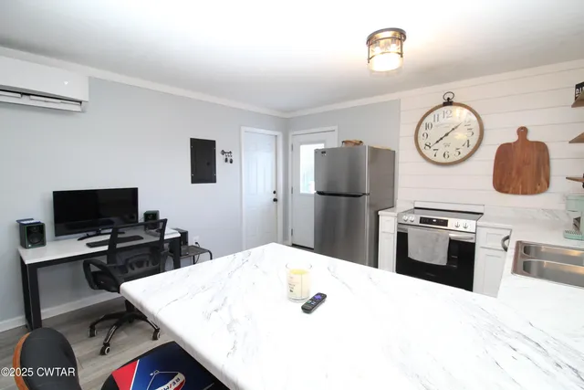 a kitchen with a appliances a refrigerator and a stove top oven