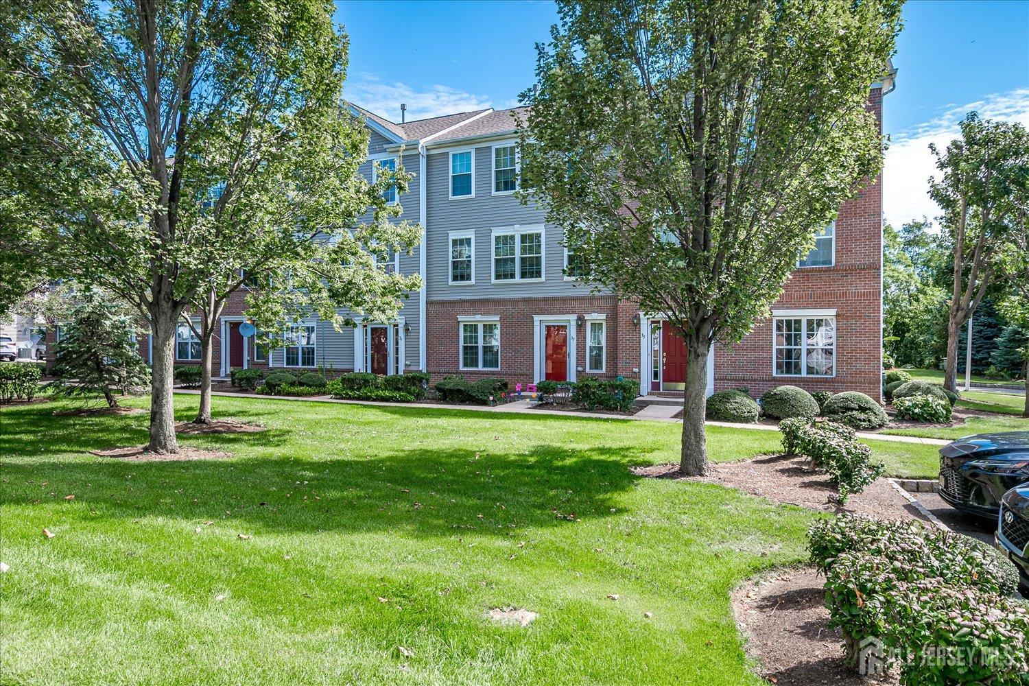 39 Rojewski Way Sayreville, NJ 08859 - Photo 1 of 40 a front view of a house with garden and trees