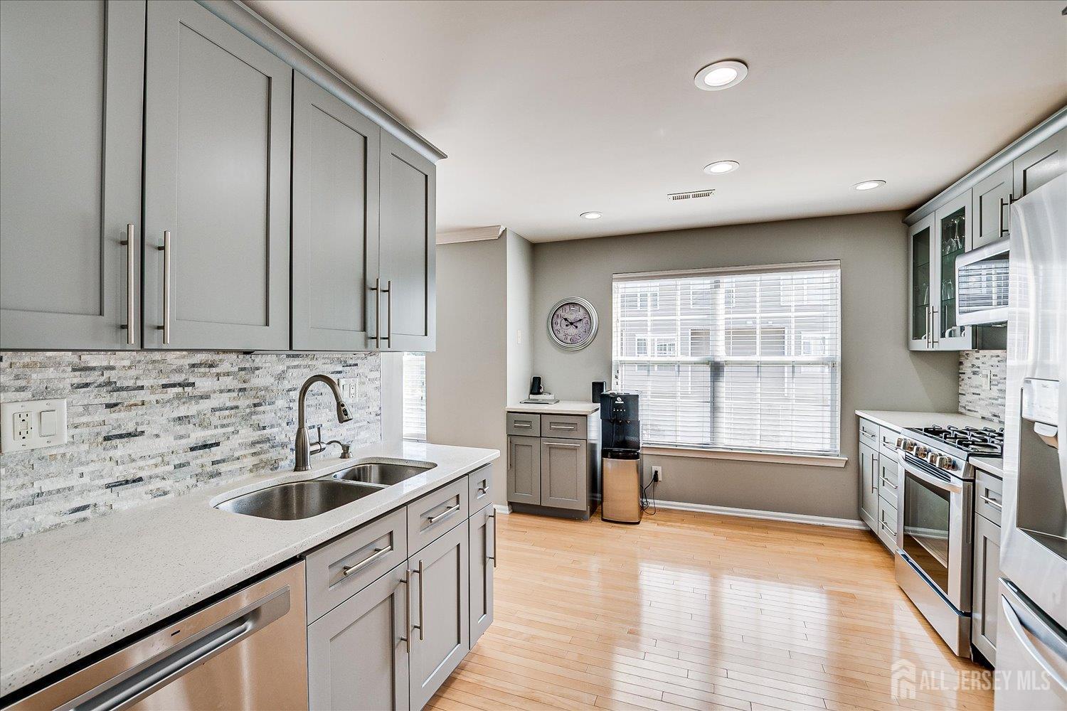 39 Rojewski Way Sayreville, NJ 08859 - Photo 17 of 40 a kitchen with a sink stove and cabinets