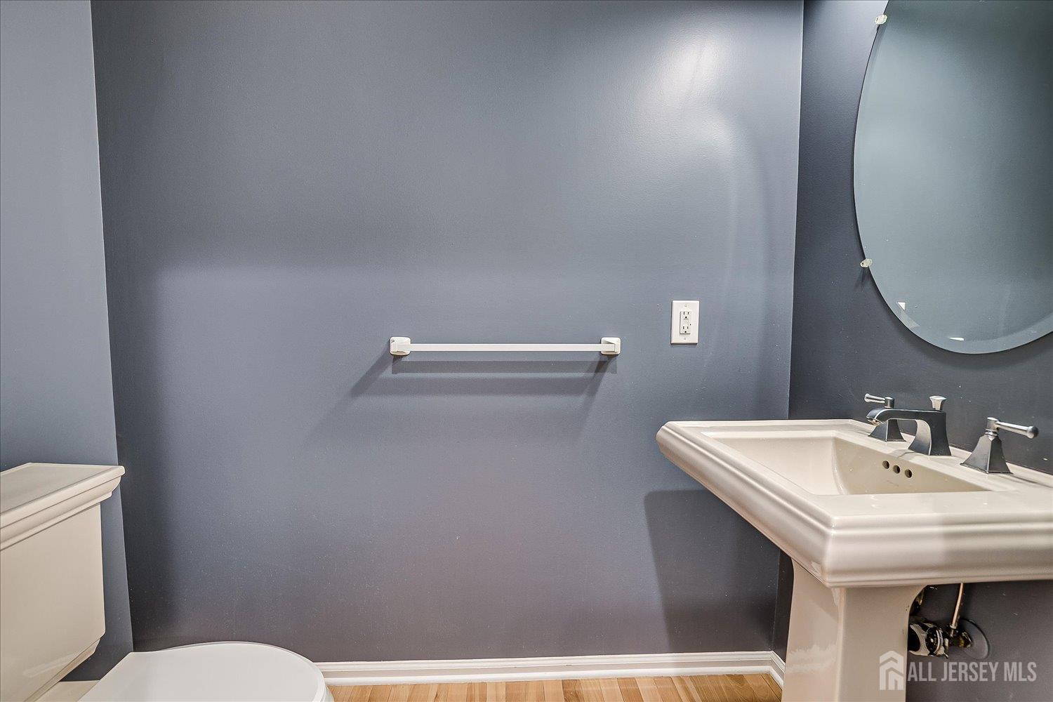 39 Rojewski Way Sayreville, NJ 08859 - Photo 20 of 40 a bathroom with a sink a toilet and mirror