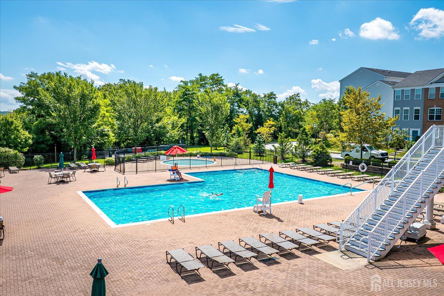 39 Rojewski Way Sayreville, NJ 08859 - Photo 35 of 40 a swimming pool with outdoor seating and yard