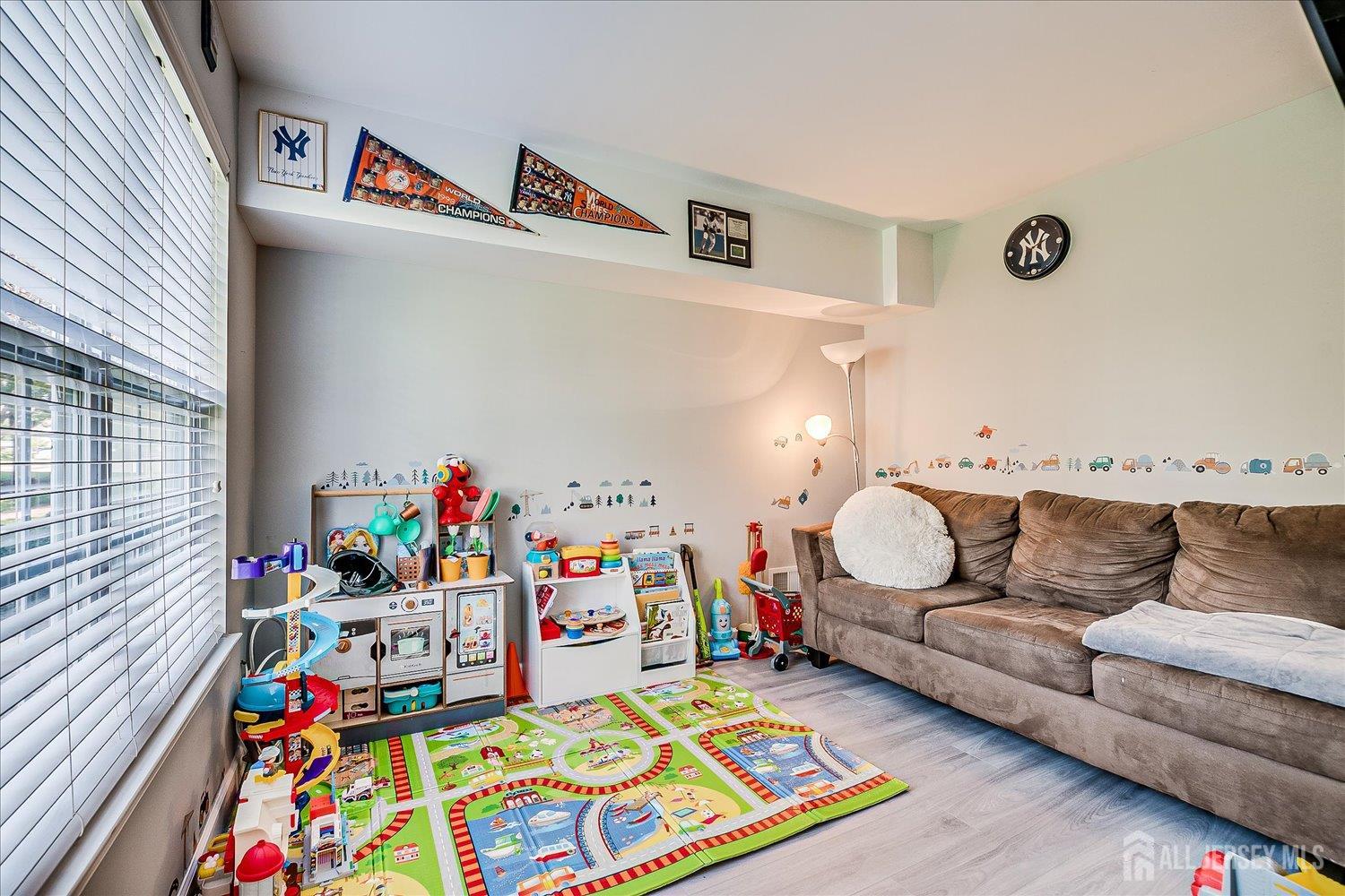 39 Rojewski Way Sayreville, NJ 08859 - Photo 8 of 40 a living room with furniture and a baby crib