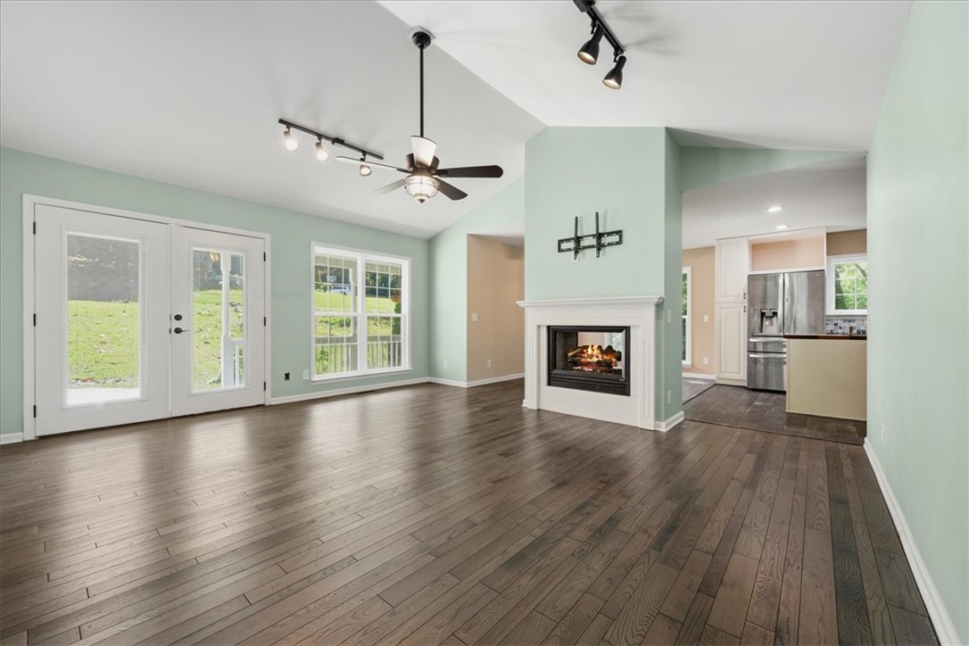 210 Briarcliff Road Central, SC 29630 - Photo 6 of 39 This inviting living area boasts rich hardwood flooring and a cozy fireplace, perfect for gatherings.