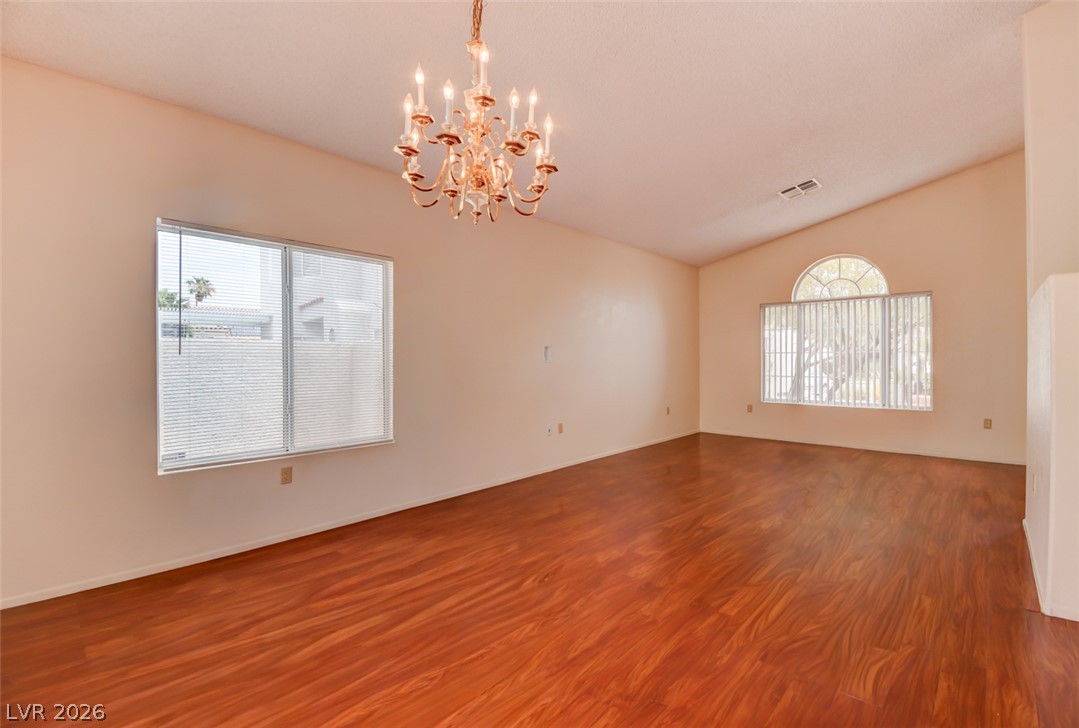 5 Tarryall Terrace Henderson, NV 89074 - Photo 6 of 44 An inviting open-concept area features warm hardwood flooring and vaulted ceilings.