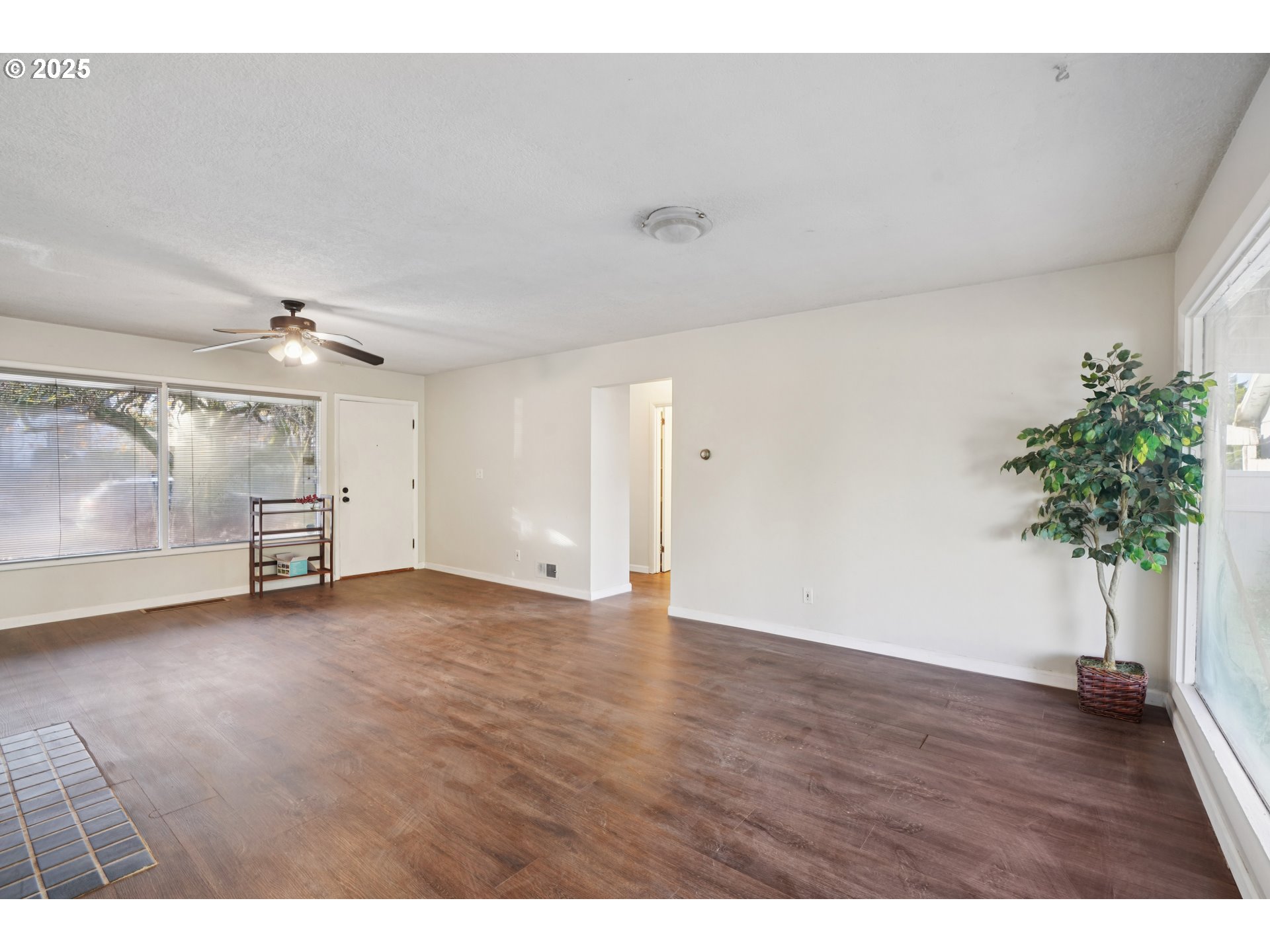 1315 North Russet Street Portland, OR 97217 - Photo 5 of 23 a view of an empty room with a potted plant and wooden floor