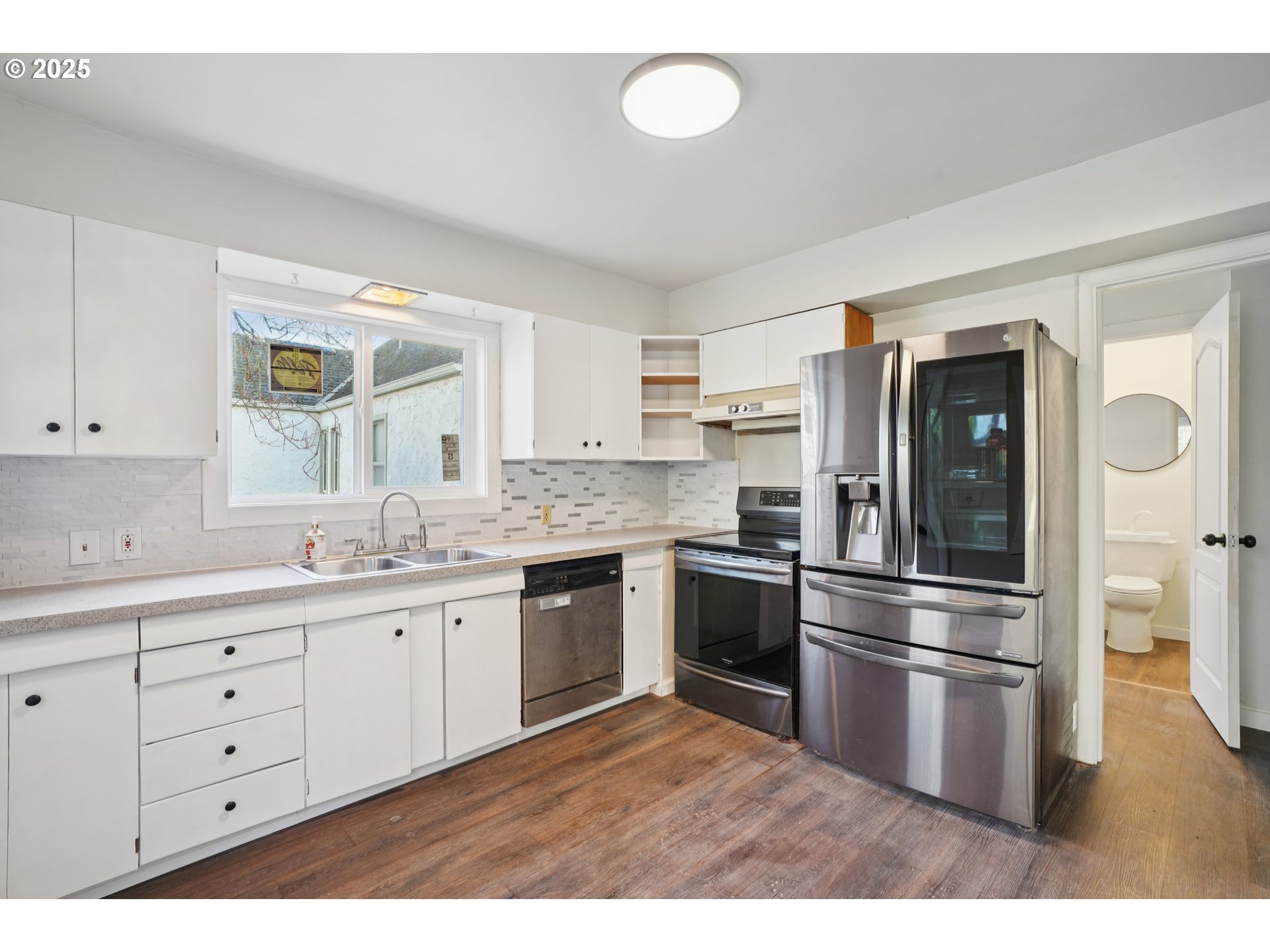 1315 North Russet Street Portland, OR 97217 - Photo 9 of 23 a kitchen with granite countertop stainless steel appliances a sink and a refrigerator