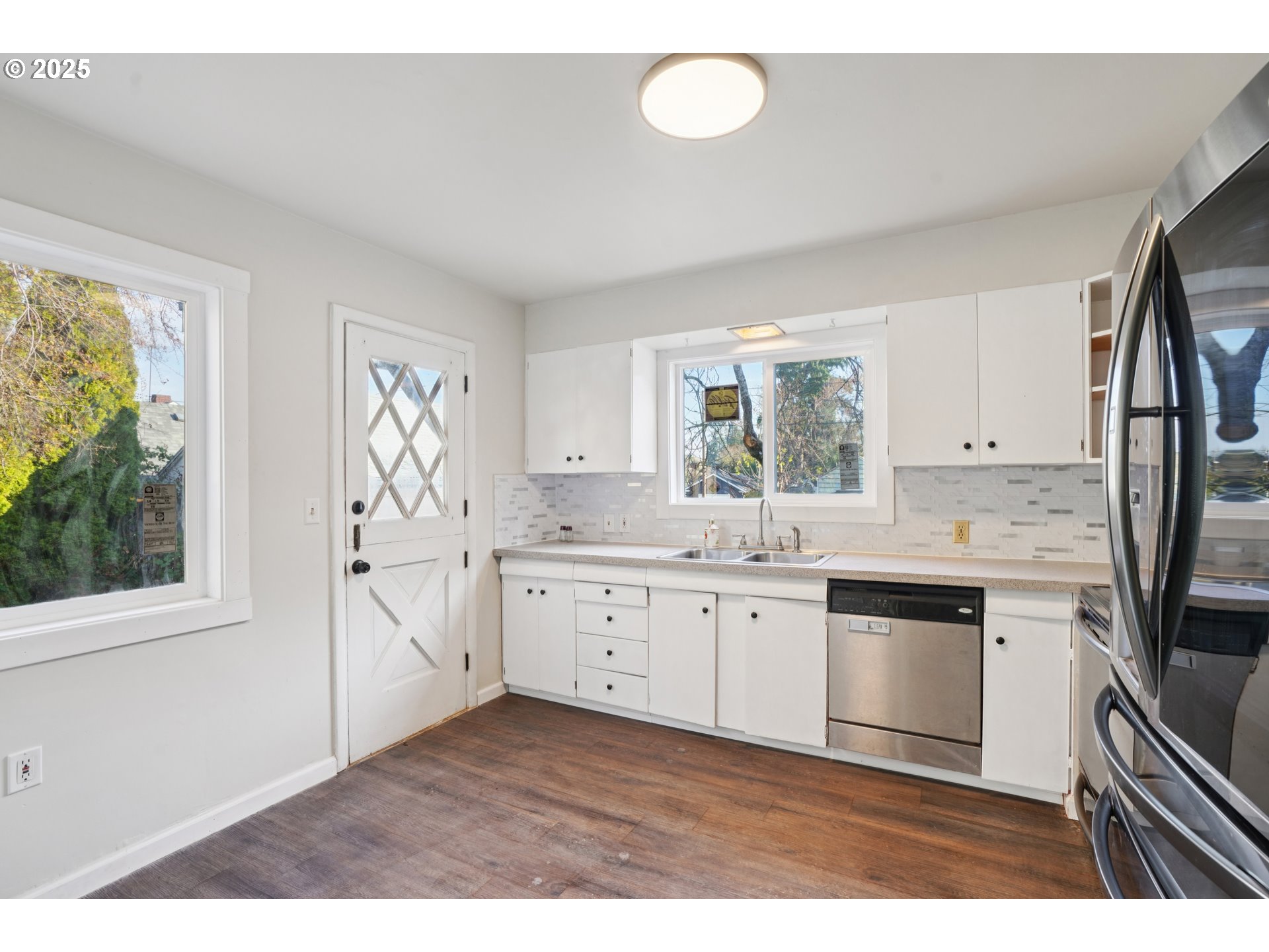 1315 North Russet Street Portland, OR 97217 - Photo 10 of 23 a kitchen with stainless steel appliances granite countertop a stove a sink and a refrigerator