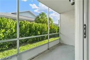 a view of a glass door with a balcony from a window