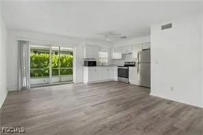 a view of a kitchen with a sink and a stove top oven