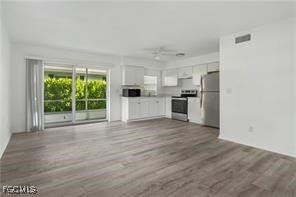 16001 Buccaneer Street, Unit 3 Bokeelia, FL 33922 - Photo 4 of 14 a view of a kitchen with a sink and a stove top oven