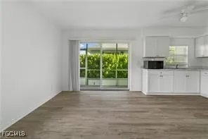 a view of livingroom with furniture flat screen tv and floor to ceiling window