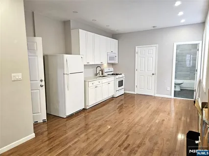 a kitchen with a refrigerator and a stove top oven