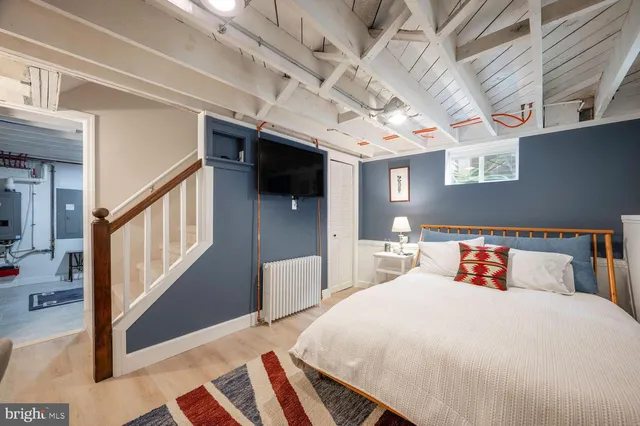 a bedroom with a large bed and a chandelier