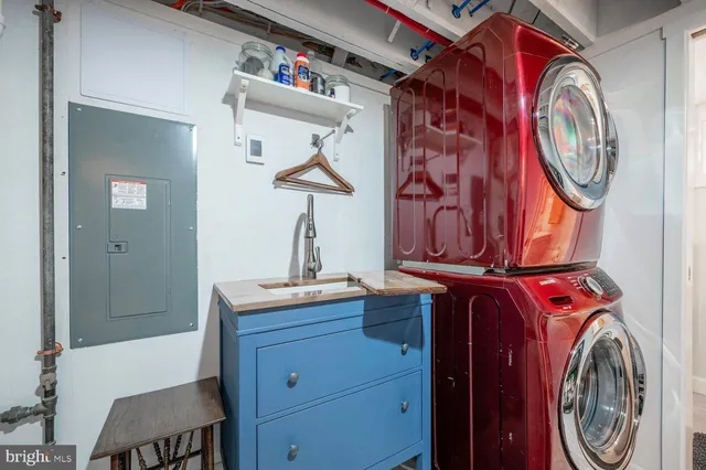 a view of a storage and utility room with washer and dryer