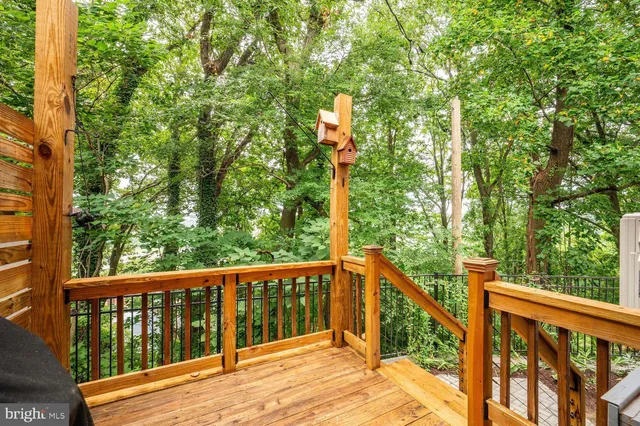 a view of balcony with wooden floor and fence