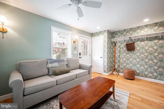 a living room with furniture and a wooden floor