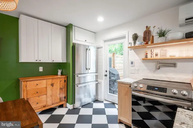 a kitchen with stainless steel appliances a stove a sink and a refrigerator