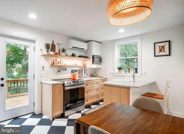 a kitchen with kitchen island granite countertop appliances cabinets and a sink
