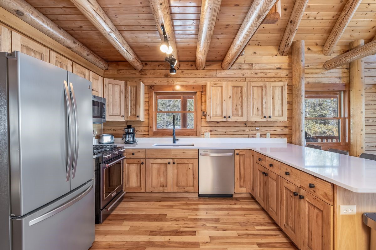 999 Bowstring Como, CO 80456 - Photo 10 of 37 a kitchen with stainless steel appliances granite countertop a refrigerator a sink dishwasher a stove and white countertops with wooden floor