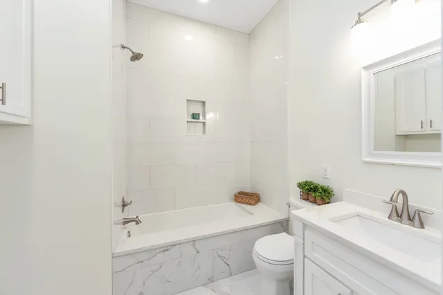 a bathroom with a sink a toilet and a tub