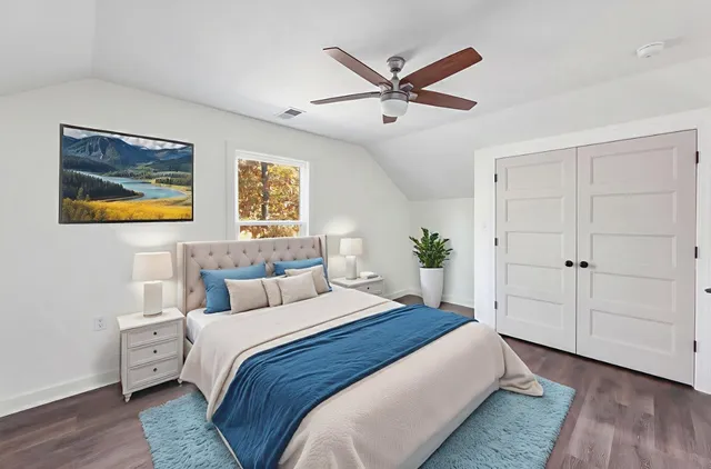 a bedroom with a large bed and a chandelier