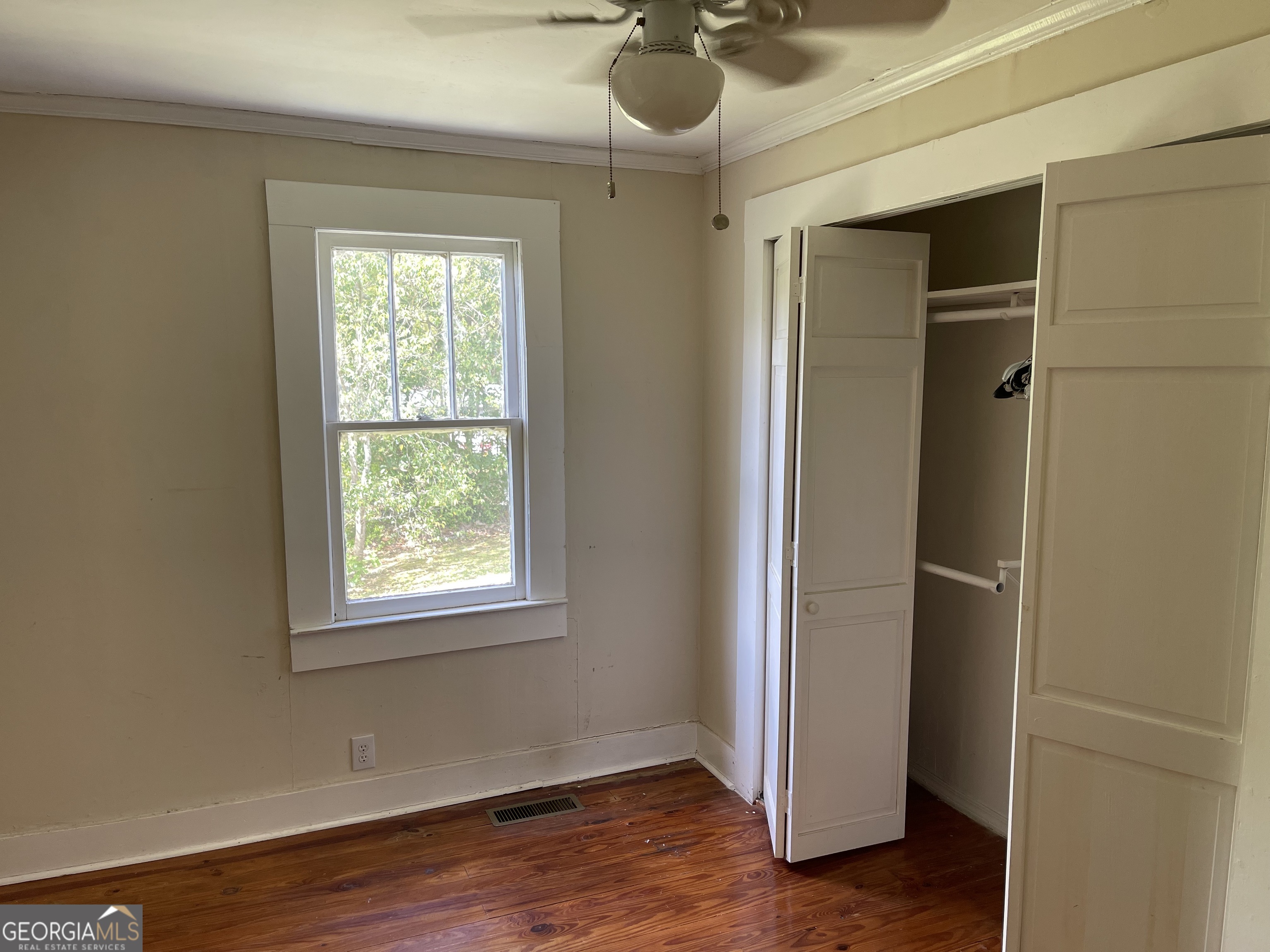 6505 23rd Avenue Valley, AL 36854 - Photo 14 of 49 a view of an empty room with a window and wooden floor
